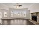 Open living room with hardwood floors, fireplace, and plenty of natural light at 1804 Quaker St, Hampton, GA 30228