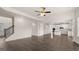 Open living space with hardwood floors, modern kitchen, and staircase at 1804 Quaker St, Hampton, GA 30228