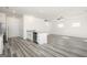 Open-concept living room showcases wood-look floors flowing into kitchen with granite countertops and stainless steel appliances at 458 Prescott Way, Villa Rica, GA 30180
