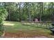 Scenic backyard showcasing a wooded area, a fence, and plenty of space for outdoor recreation at 142 Carrollwood Dr, Fayetteville, GA 30215