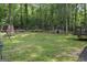 Expansive backyard enclosed by a wooden fence with a storage shed and lush trees at 142 Carrollwood Dr, Fayetteville, GA 30215