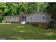 Single-story home featuring multiple windows and a well-maintained lawn at 142 Carrollwood Dr, Fayetteville, GA 30215
