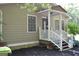 Inviting front porch with fresh mulch and a charming welcome sign by the front door at 142 Carrollwood Dr, Fayetteville, GA 30215