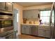 Well-equipped kitchen with gray cabinets, a stainless dishwasher and sink at 142 Carrollwood Dr, Fayetteville, GA 30215