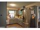 Bright kitchen with gray cabinets, stainless steel appliances, and ample counter space at 142 Carrollwood Dr, Fayetteville, GA 30215