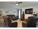 Spacious living room featuring a fan, large TV, and comfortable seating at 142 Carrollwood Dr, Fayetteville, GA 30215