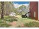 Spacious backyard featuring a detached building, lush lawn, and complemented by mature trees for added privacy at 270 Morrow Rd, Newborn, GA 30056