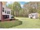 Large backyard featuring a detached building, mature trees, and a well-manicured lawn, perfect for outdoor enjoyment at 270 Morrow Rd, Newborn, GA 30056
