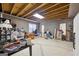 Unfinished basement with exposed ceiling beams, concrete floor, and natural light from multiple windows at 270 Morrow Rd, Newborn, GA 30056