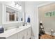 Bathroom features white vanity, framed mirror and tile floor at 270 Morrow Rd, Newborn, GA 30056