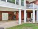 Spacious covered patio with white pillars, double doors, and brick columns at 270 Morrow Rd, Newborn, GA 30056