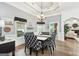 Dining area with tray ceiling, modern chandelier and views into the kitchen at 270 Morrow Rd, Newborn, GA 30056