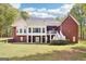 Rear exterior view of a two-story home, featuring a deck, brick facade, and well-maintained lawn at 270 Morrow Rd, Newborn, GA 30056