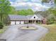 Stately brick home features a circular drive, three-car garage, and covered entryway at 270 Morrow Rd, Newborn, GA 30056