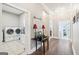 Inviting hallway with hardwood floors and views into laundry room with appliances at 270 Morrow Rd, Newborn, GA 30056