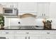 Close-up of kitchen with cooktop, white subway tile backsplash, and white cabinets at 270 Morrow Rd, Newborn, GA 30056