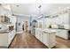 Bright, spacious kitchen with white cabinets, stainless steel appliances, and hardwood floors at 270 Morrow Rd, Newborn, GA 30056