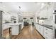 Open kitchen with island, white cabinetry, modern appliances and hardwood floors at 270 Morrow Rd, Newborn, GA 30056
