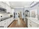 Kitchen featuring stainless appliances, white cabinetry, and views to the breakfast and laundry room at 270 Morrow Rd, Newborn, GA 30056
