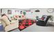 Cozy living room featuring comfortable seating, vibrant red accents, and a stylish rug at 270 Morrow Rd, Newborn, GA 30056