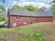 Long rear view of the red brick home showing the back and side at 270 Morrow Rd, Newborn, GA 30056