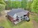 Stately brick home featuring a screened porch, deck, and backyard with mature trees at 270 Morrow Rd, Newborn, GA 30056