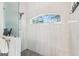 Bright shower featuring a glass door, rainfall shower head, and a charming window at 270 Morrow Rd, Newborn, GA 30056