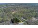 Overhead view of the property with mature trees and surrounding landscape at 9995 Huntcliff Trce, Atlanta, GA 30350