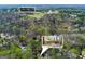 Stunning aerial view of property near Cherokee Town & Country Club with mature trees at 9995 Huntcliff Trce, Atlanta, GA 30350