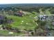 Picturesque aerial view of a golf course and country club surrounded by lush greenery and mature trees at 9995 Huntcliff Trce, Atlanta, GA 30350
