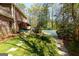 Lush backyard features a brick home, large brick patio, and a covered in-ground pool at 9995 Huntcliff Trce, Atlanta, GA 30350