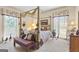 Serene bedroom with a four-poster bed, soft lighting, and decorative accents, designed for relaxation at 9995 Huntcliff Trce, Atlanta, GA 30350