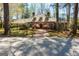 Charming brick home featuring a wood roof, dormer windows, mature trees, and a welcoming brick walkway at 9995 Huntcliff Trce, Atlanta, GA 30350