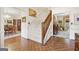 Welcoming foyer with hardwood floors, carpeted staircase, and views into the dining room and living room at 9995 Huntcliff Trce, Atlanta, GA 30350