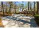 Scenic front exterior with lush greenery and long driveway at 9995 Huntcliff Trce, Atlanta, GA 30350