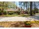 Inviting exterior view of home featuring manicured lawn and seasonal flower at 9995 Huntcliff Trce, Atlanta, GA 30350