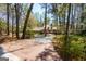 Charming front exterior of home with circular driveway and mature landscaping at 9995 Huntcliff Trce, Atlanta, GA 30350