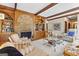 Inviting living room with wood-paneled walls, fireplace, and comfortable seating, perfect for gatherings at 9995 Huntcliff Trce, Atlanta, GA 30350