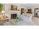 Cozy living room features a classic fireplace, plush seating, and refined decor in neutral tones at 9995 Huntcliff Trce, Atlanta, GA 30350