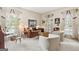 Sunlit living room with large windows, comfortable seating, and stylish accents, creating a relaxing atmosphere at 9995 Huntcliff Trce, Atlanta, GA 30350