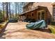 A brick patio off the rear of the home features multiple seating arrangements and room to entertain at 9995 Huntcliff Trce, Atlanta, GA 30350