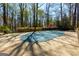 A covered in-ground pool with an expansive cement patio and surrounding garden at 9995 Huntcliff Trce, Atlanta, GA 30350