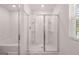 Modern bathroom featuring a walk-in shower with sliding glass doors, built-in shelving, and a soaking tub at 1483 Autumn Wind Dr # 24, Dacula, GA 30019