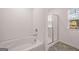 Bathroom featuring a soaking tub and a glass enclosed shower with a window at 1483 Autumn Wind Dr # 24, Dacula, GA 30019