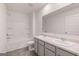 Bathroom featuring double sinks, a large mirror, vinyl floors and a tub with shower at 1483 Autumn Wind Dr # 24, Dacula, GA 30019