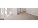 Bright bedroom featuring neutral carpet, white walls, and multiple white paneled doors at 1483 Autumn Wind Dr # 24, Dacula, GA 30019