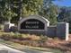 Stone entrance sign for Brooks Village with manicured landscaping and vibrant foliage at 1483 Autumn Wind Dr # 24, Dacula, GA 30019