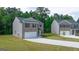 New construction two story home with brick and siding exterior, two car garage, and a driveway at 1483 Autumn Wind Dr # 24, Dacula, GA 30019