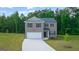 Charming two-story home with a brick facade, well-manicured lawn, and attached two-car garage at 1483 Autumn Wind Dr # 24, Dacula, GA 30019