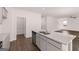 Spacious kitchen island with granite countertops, stainless steel appliances, and wood flooring at 1483 Autumn Wind Dr # 24, Dacula, GA 30019